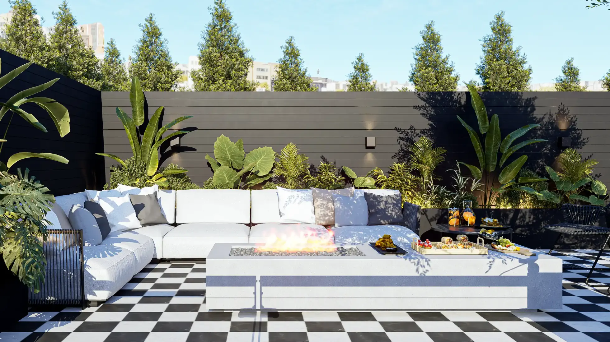 Decoração de zona lounge com lareira em terraço de apartamento integralmente remodelado e decorado por Margarida Bugarim Zona lounge de terraço com sofá branco em L, lareira exterior, vegetação tropical e pavimento em mosaicos pretos e brancos